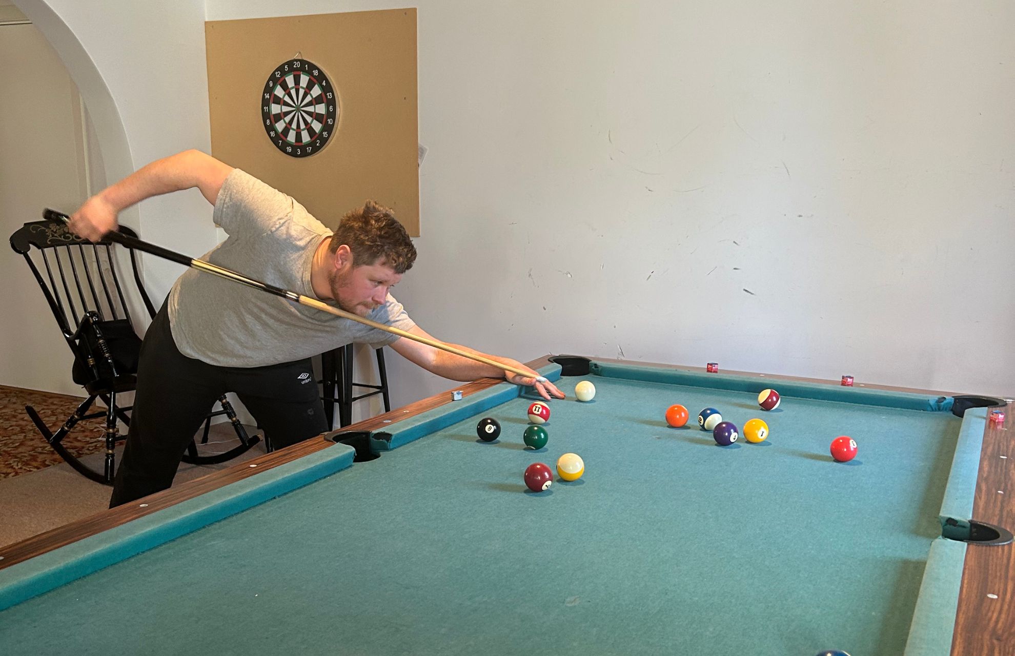Johannes spelar biljard i gruppbostaden.
